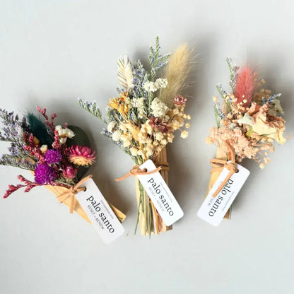 Three handmade palo santo floral bouquets with twine ties