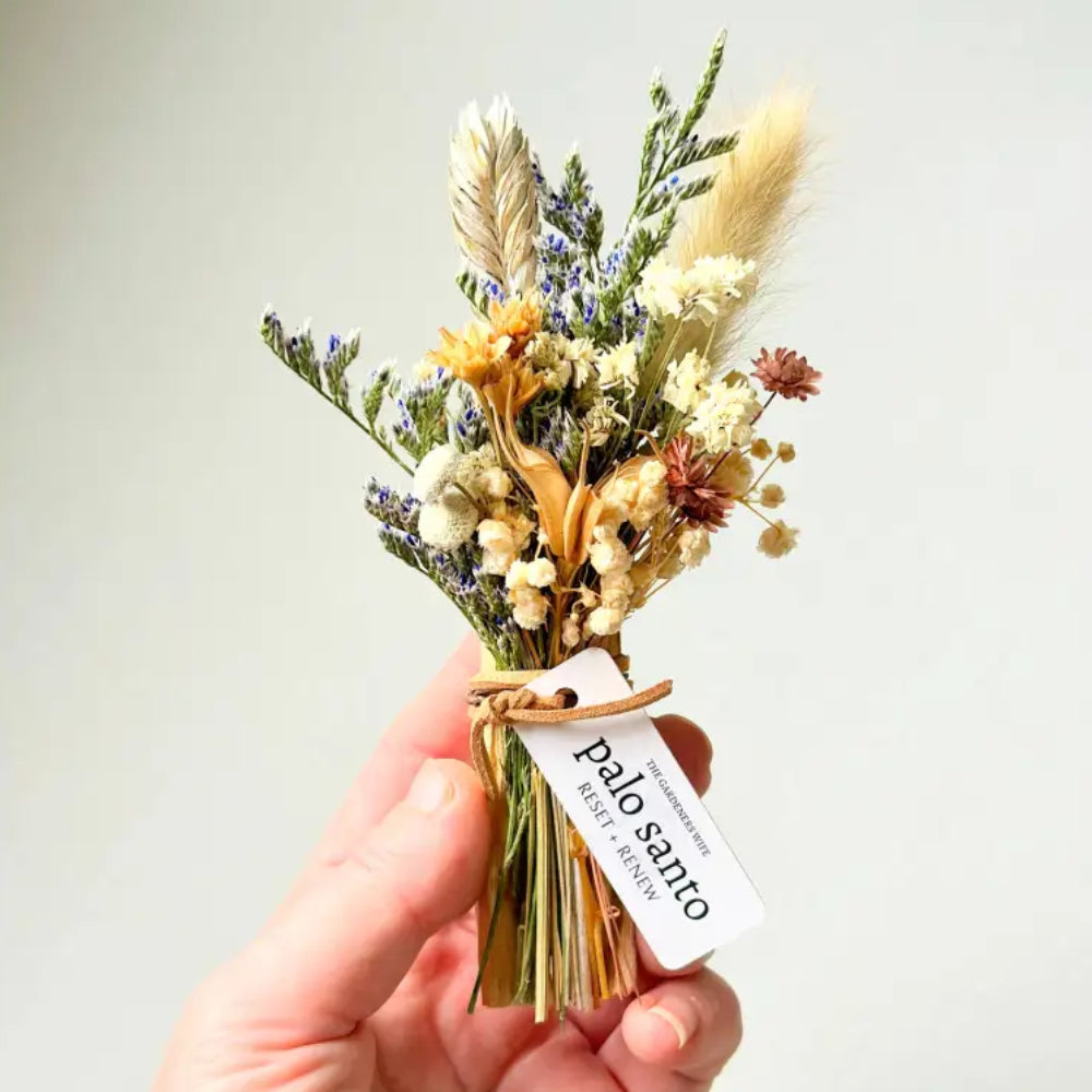 Handmade eco-friendly Palo Santo + Flora dried floral arrangement in beige, cream, purple hues with twine bow