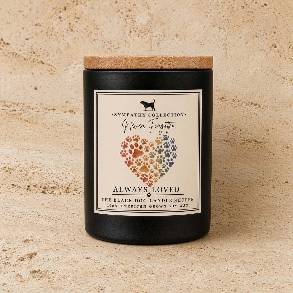 Black handmade soy candle with wooden lid featuring rainbow paw print heart and never forgotten label for pet sympathy