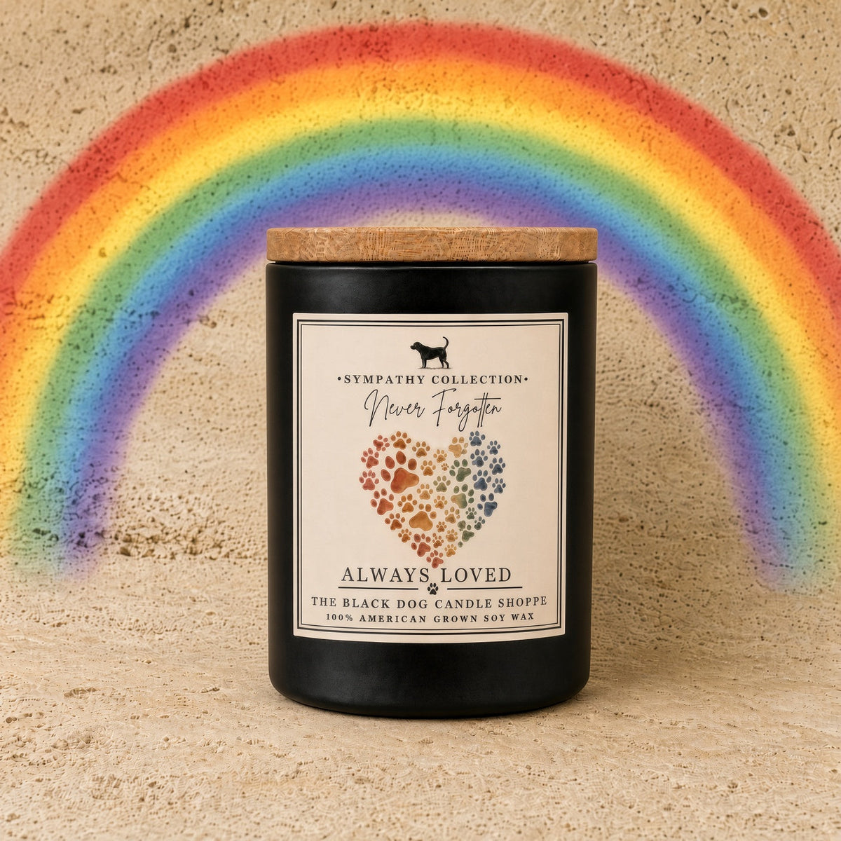 Black cylindrical handmade soy wax candle with wooden lid and rainbow paw print label from black dog candle shoppe