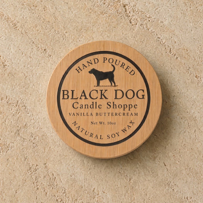 A round wooden lid with a black dog silhouette and engraved text for a handmade eco-friendly pet sympathy candle