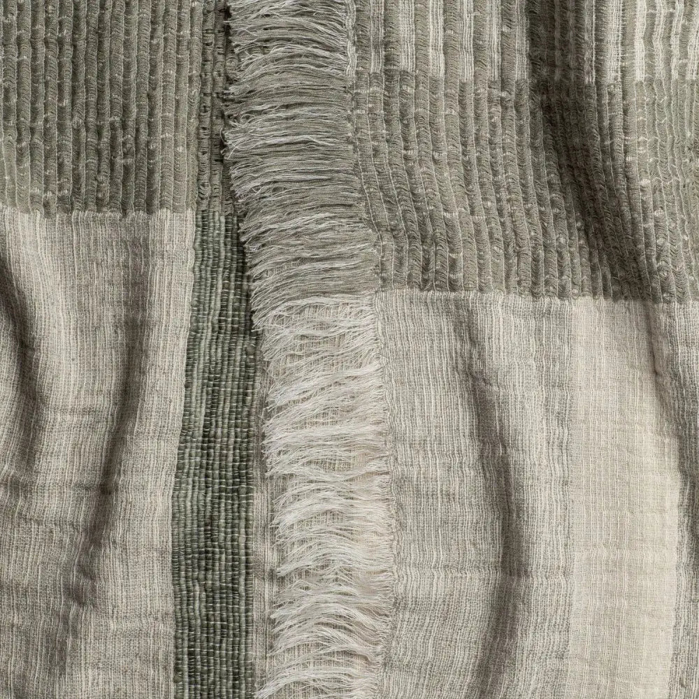 Gray and white striped scarf with frayed edges, perfect as a plaid throw blanket in soft ivory and sage green
