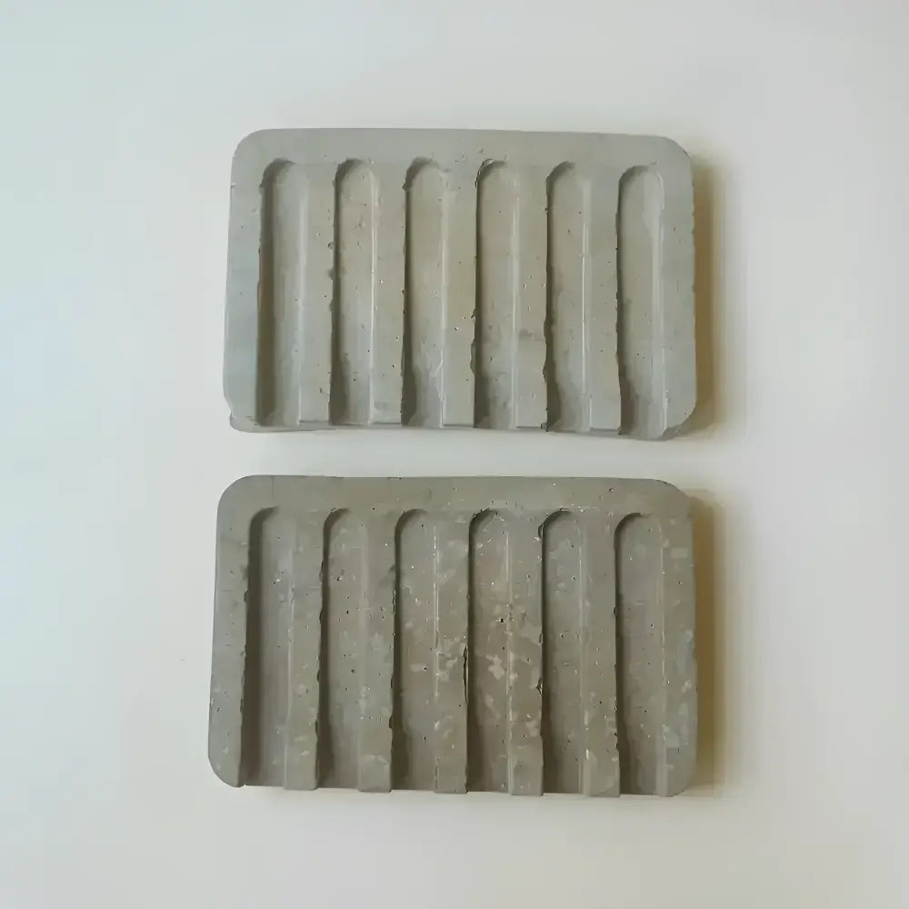 Hand poured concrete and botanical powders soap dishes in brown or gray.