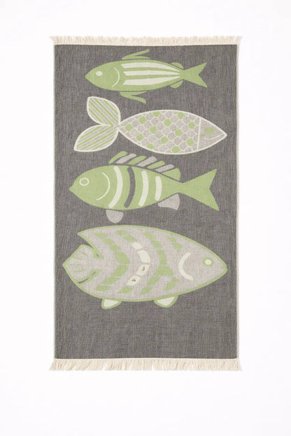 Gray woven turkish cotton beach towel with four light green and white stylized fish perfect as a sand repellent beach blanket