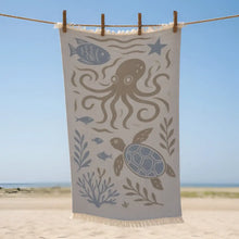 Beige premium authentic turkish muslin beach towel with blue and brown sea creatures design including octopus and turtle