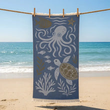 Blue beach towel with white and gold sea creatures made of premium authentic turkish muslin cotton