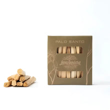 Eight Palo Santo sticks for smudging in a recycled cardboard box.