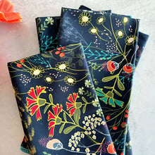 Stack of pretty peacock cloth napkins with colorful floral pattern for stylish table setting