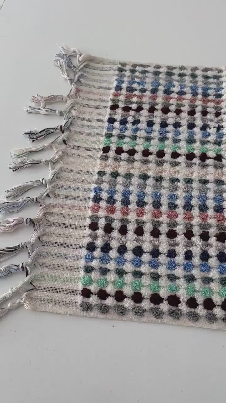 Video of handcrafted Turkish terrycloth cotton oversized hand towel with pastel colored dots.