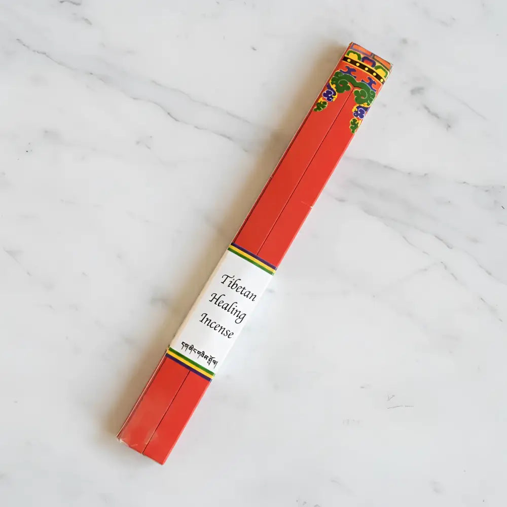 Red rectangular box of pure natural healing incense made by tibetan nuns from khachoe ghakyil ling with colorful patterns