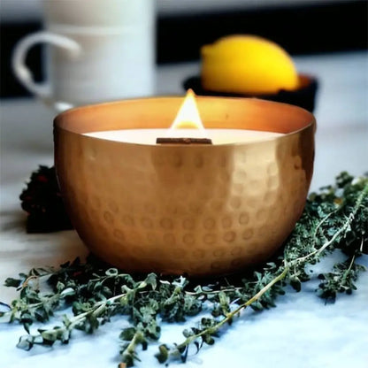 Lit soy candle with wooden wick in a hammered solid brass bowl, crushed thyme herb scent
