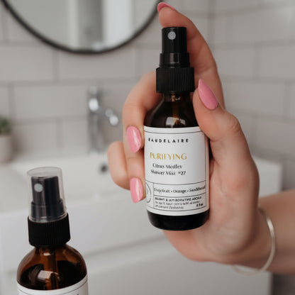 Sleek amber glass spray bottle of Baudelaire Purify Citrus Medley Shower Mist