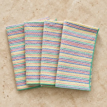 Set of four rainbow seersucker cloth napkins with vibrant multicolored horizontal stripes in a textured weave