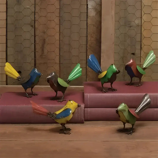 Colorful bird-shaped sculptures on a wooden surface with a patterned wall in the background