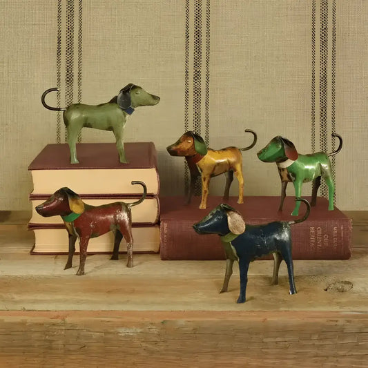 Metal Dogs figurines standing on books