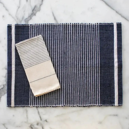 Adwa Recycled Cotton Placemat in Navy on a marble surface