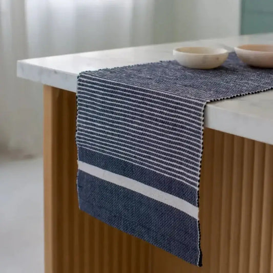 Adwa Recycled Cotton Table Runner - Navy on a counter