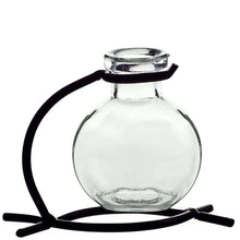 Recycled glass mini vase with black metal stand holding pink flowers