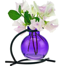 Recycled glass mini vase with black metal stand holding purple vase and pink white sweet peas
