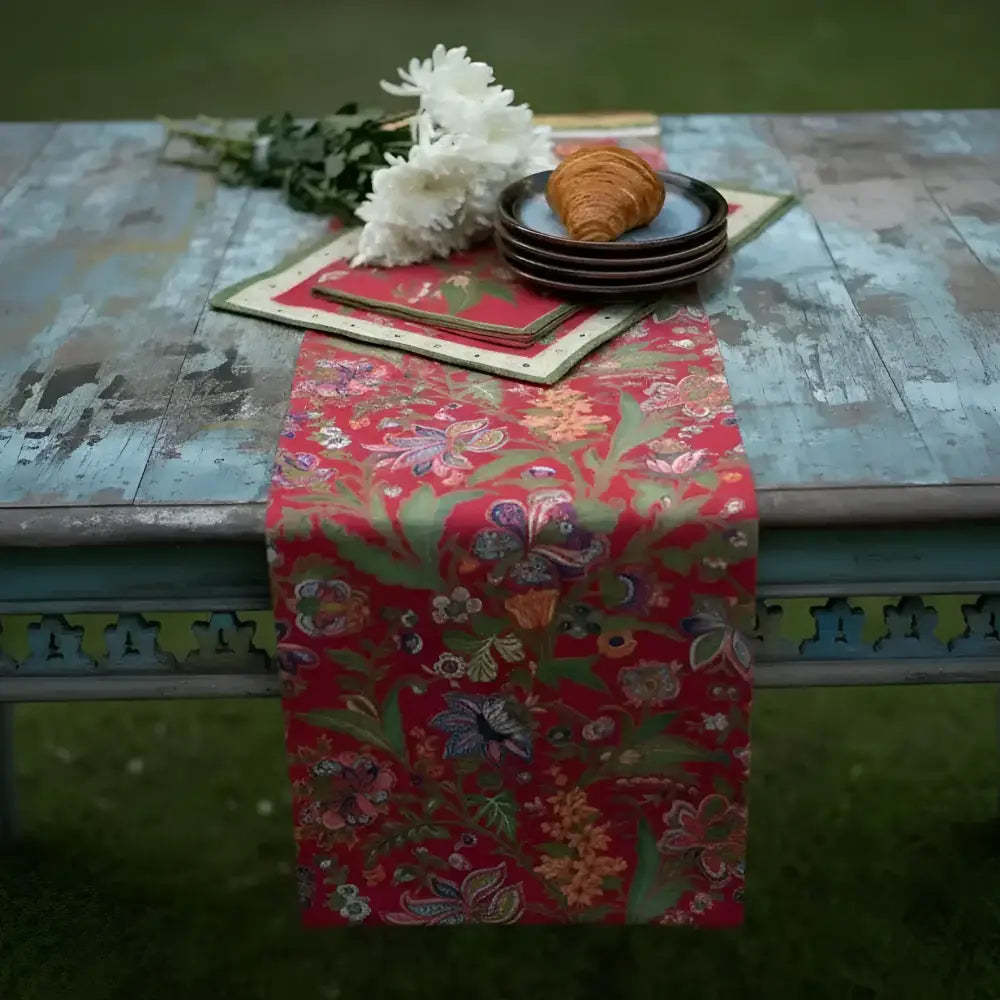 Handmade red floral table runner with green leaves and gold accents