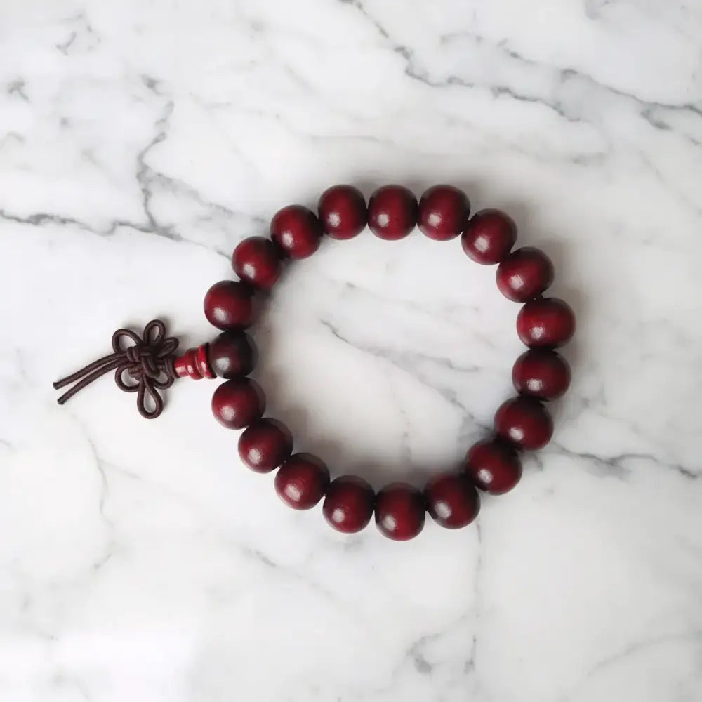 Deep red plain 8mm rosewood bracelet with dark brown knotted cord closure perfect for essential oils use