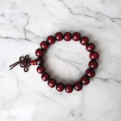 Deep red plain 8mm rosewood bracelet with dark brown knotted cord closure perfect for essential oils use