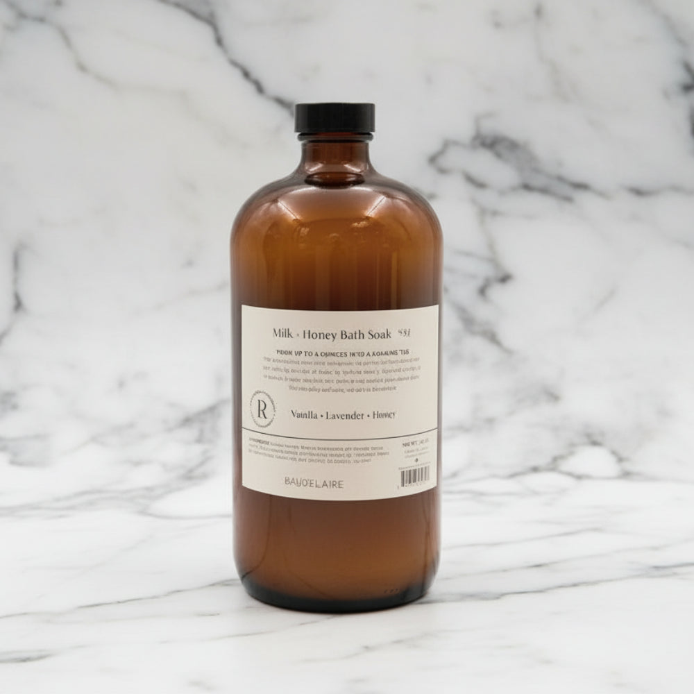 Handcrafted Baudelaire Milk + Honey Bath Soak in amber glass bottle