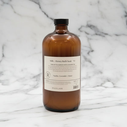 Handcrafted Baudelaire Milk + Honey Bath Soak in amber glass bottle