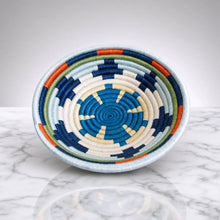 Handwoven rings small sisal bowl with hanging loop featuring blue white orange and green concentric rings