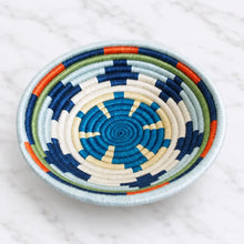 Handwoven rings small sisal bowl with concentric blue white green and orange rings and hanging loop detail