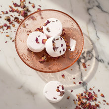 White rose bath bomb topped with dried petals in vintage glass dish