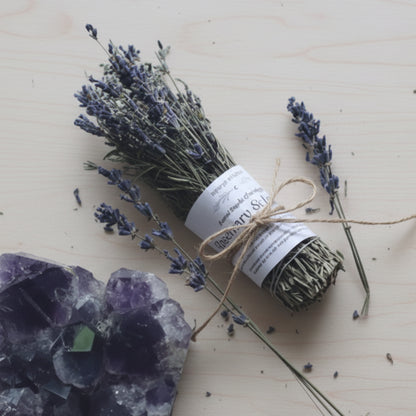 Handmade rosemary and lavender sacred smoke cleansing stick with dried lavender bundle tied in green ribbon