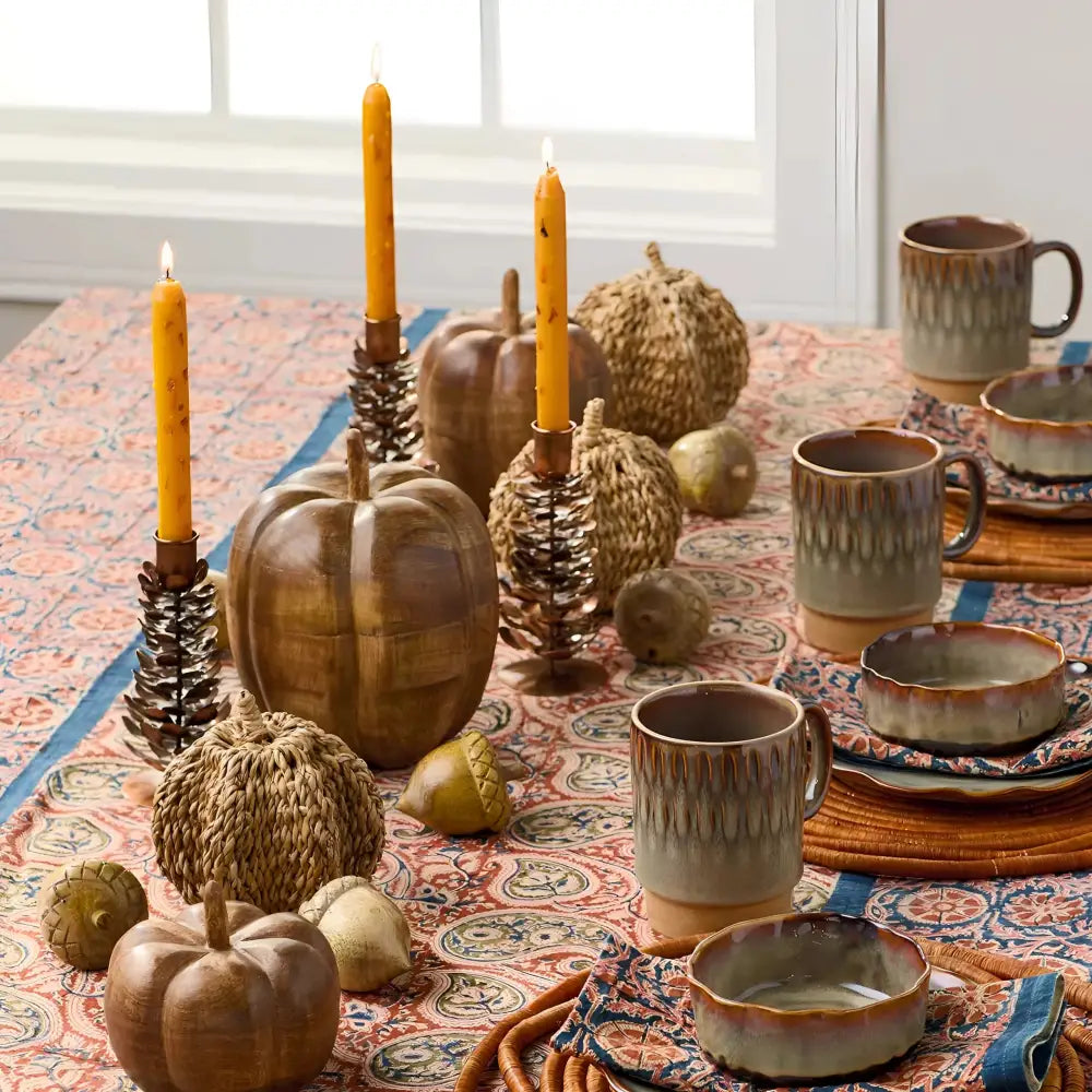 Ceramic pumpkin candle holders with pinecone accents and earthy tones for cozy decor