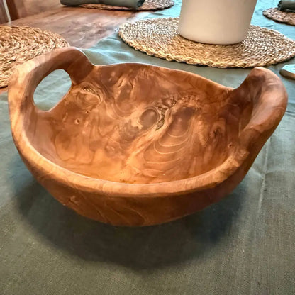 Rustic teak bowl with handles showing natural grain patterns perfect for home decor or serving