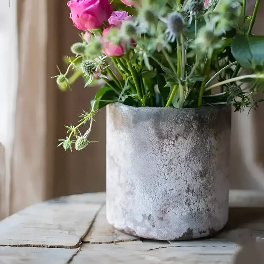 A rust and blue colored glass vase with a textured design.