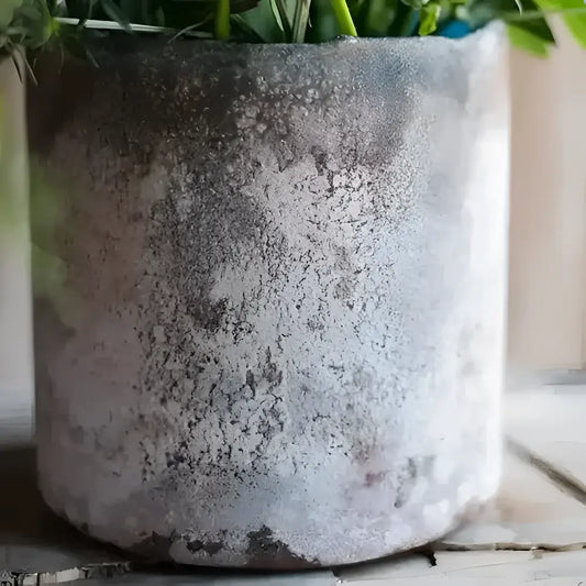 A rust and blue colored glass vase with a textured design.