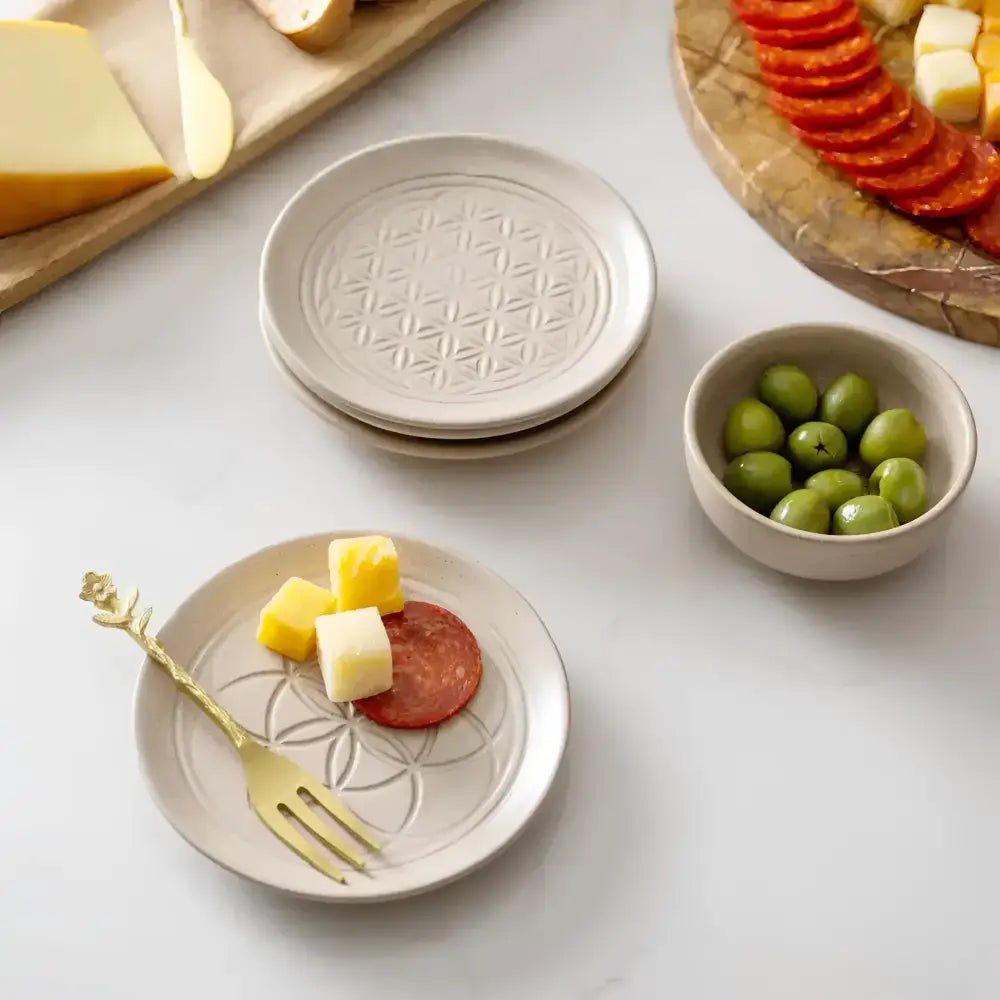 four ceramic plates with a geometric design