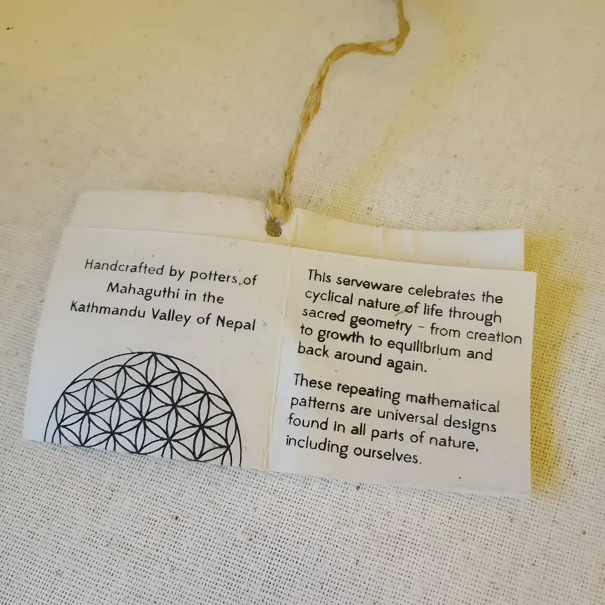 White paper tag with string on Sacred Designs Appetizer Plates with unique embossed patterns