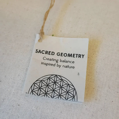 White tag with unique embossed patterns and string on Sacred Designs Appetizer Plates