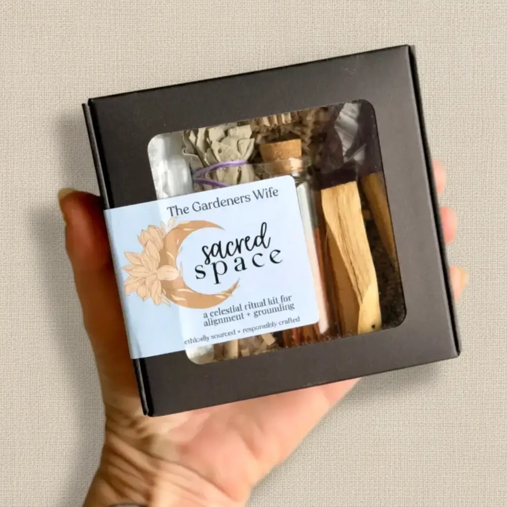 Black box celestial ritual kit with palo santo stick sage bundles and dried herbs for creating intentional space and grounding
