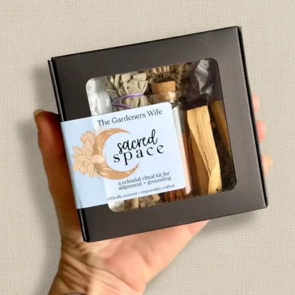 Black box celestial ritual kit with palo santo stick sage bundles and dried herbs for creating intentional space and grounding