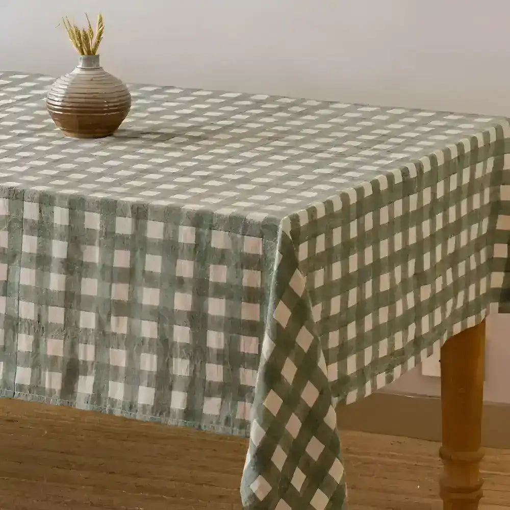 Fabric covering on wood table with green checkered pattern.