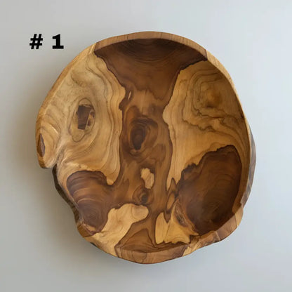 Large live edge hand carved wooden bowl made from salvaged teak roots with warm amber and deep brown tones