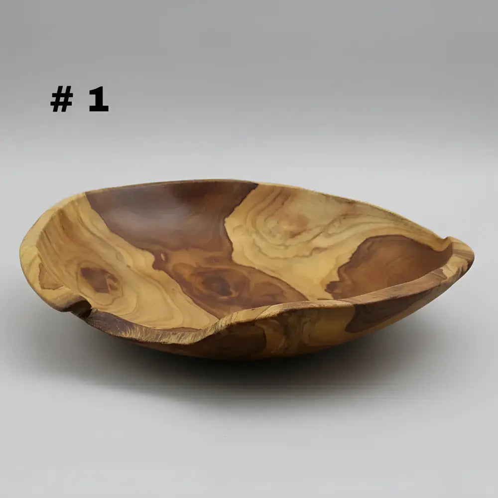 Large live edge hand carved wooden bowl made from salvaged teak roots with warm golden and deep brown grain patterns