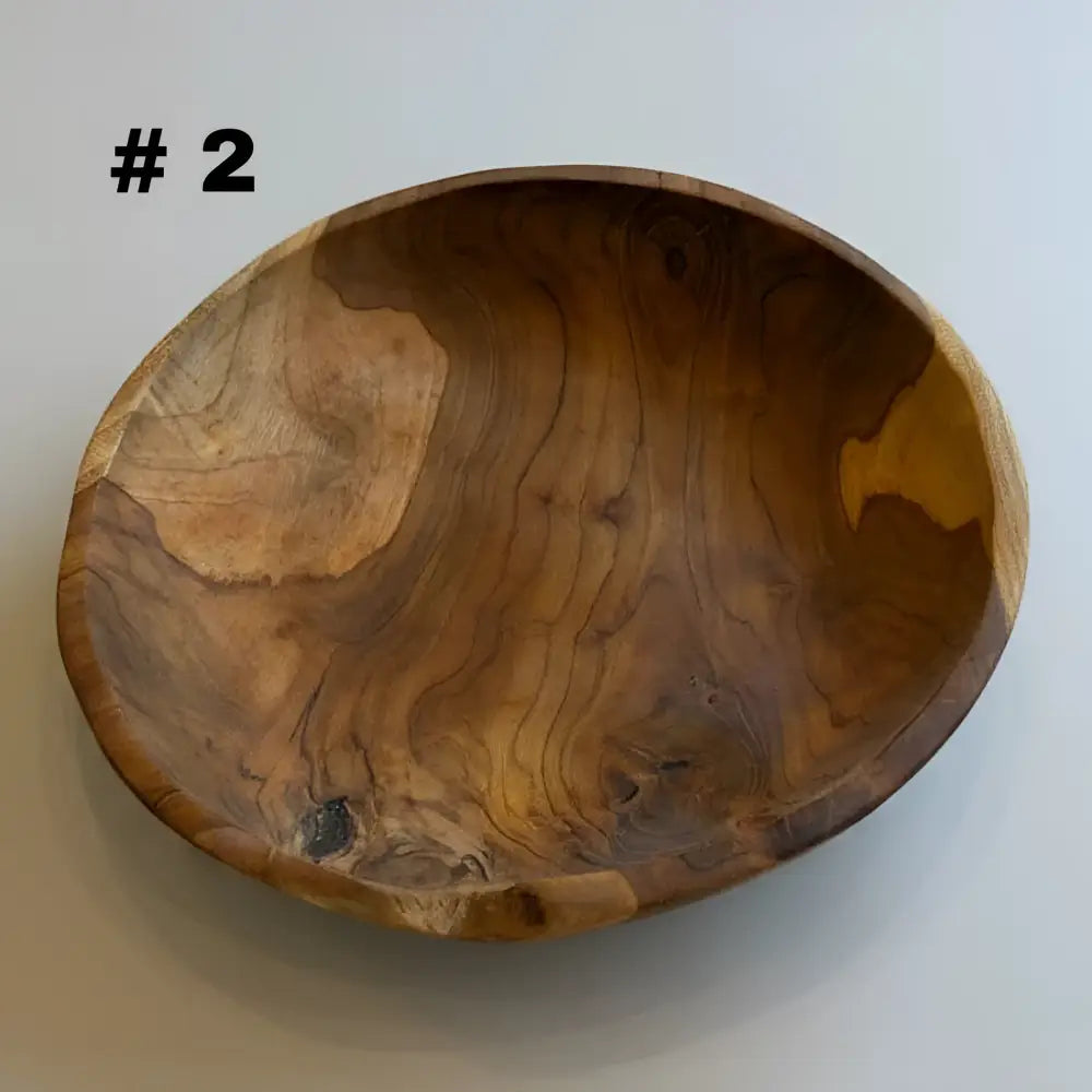 Large live edge hand carved wooden bowl made from salvaged teak roots with warm earthy tones and natural grain patterns