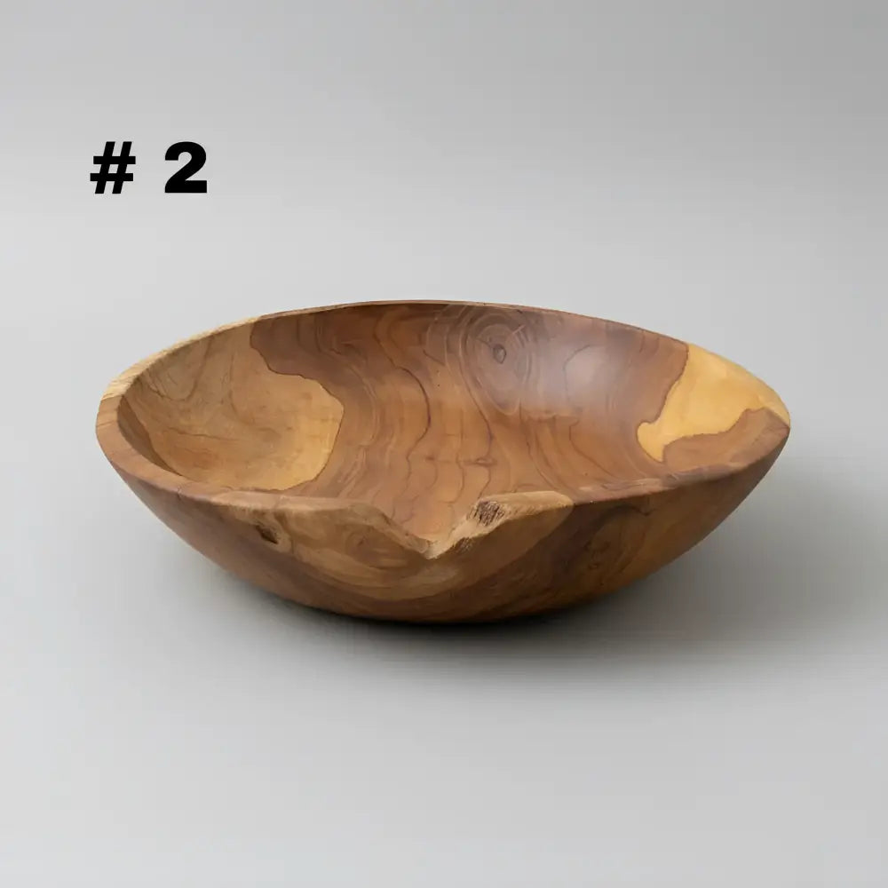 Large live edge hand carved wooden bowl made from warm earthy salvaged teak roots with natural swirling grain patterns
