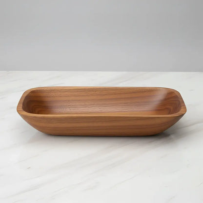 Smooth rectangular salvaged teak root wooden serving dish with warm brown finish and visible grain patterns perfect as bread bowls