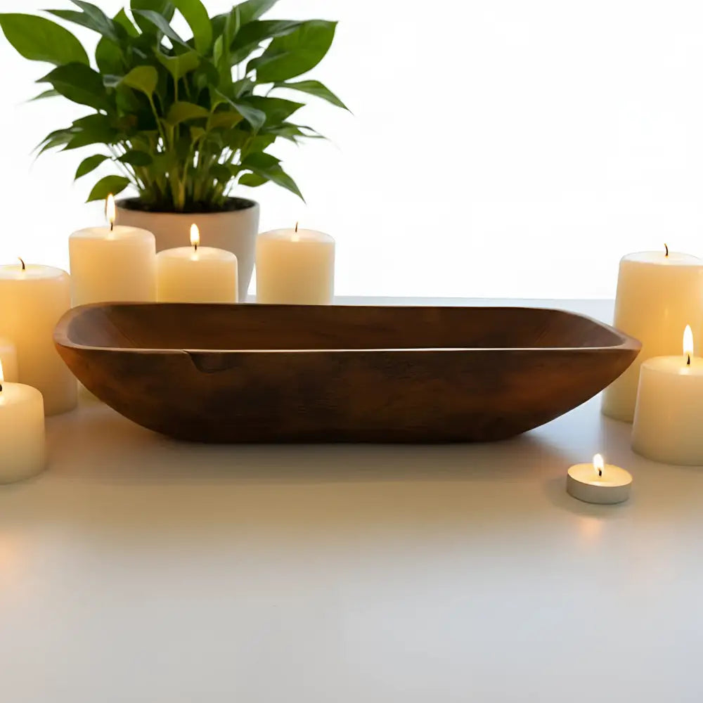 A smooth dark brown salvaged teak root oval bowl with a gently curved rectangular shape perfect for bread bowls