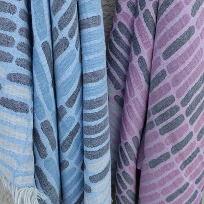 Cotton towel with gauze texture with a geometric woven design and eyelash fringe.