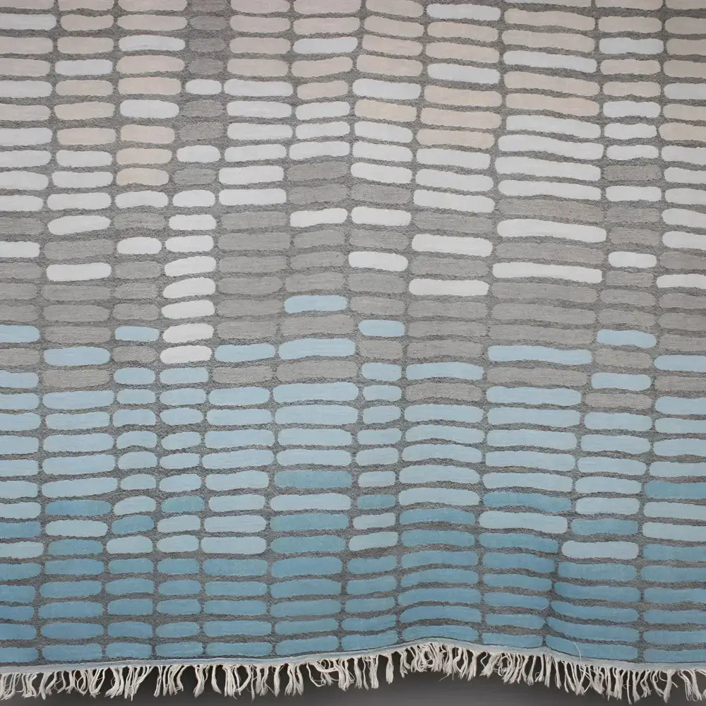 Cotton towel with gauze texture with a geometric woven design and eyelash fringe.